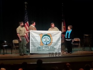 Ga. Forestry Commission officials present Toccoa with a "Tree City USA" banner